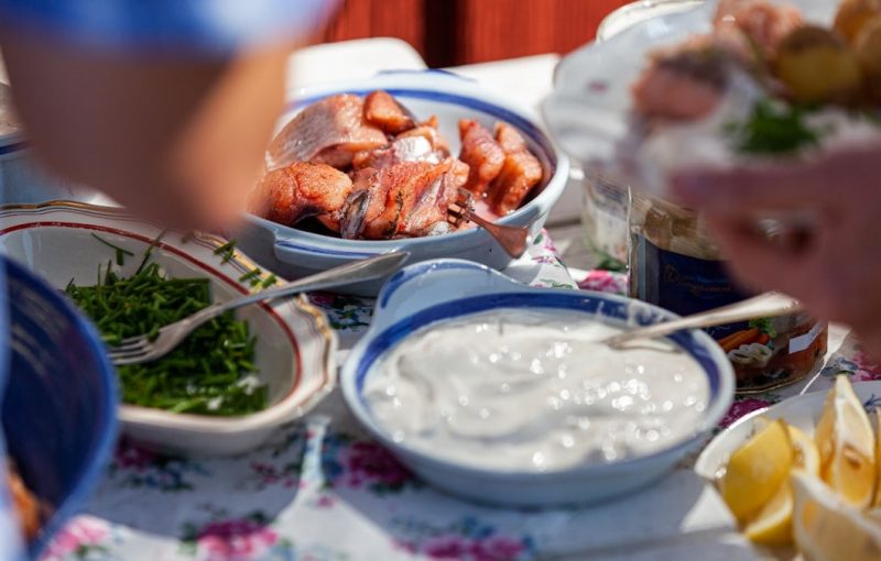 A traditional Swedish Midsummer lunch begins with herring and potatoes.